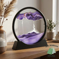 Purple 3D sandscape picture with layered sand patterns in a round black frame and stand