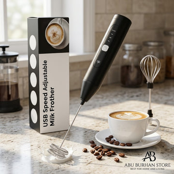 Black rechargeable coffee frother with double-coil whisk, balloon whisk attachment and coffee cup beside product box.